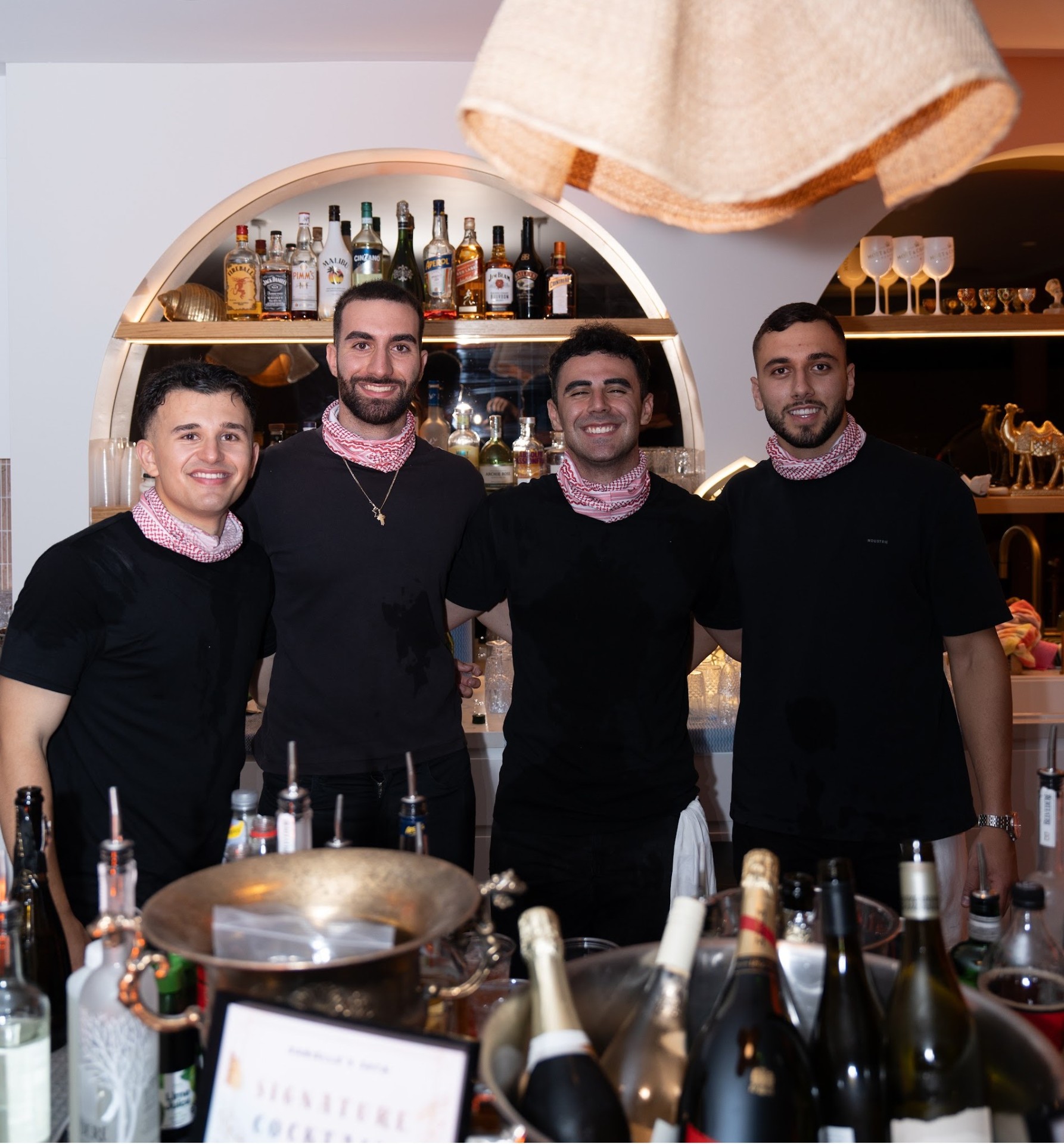 The Boys Behind The Bar team smiling behind the bar