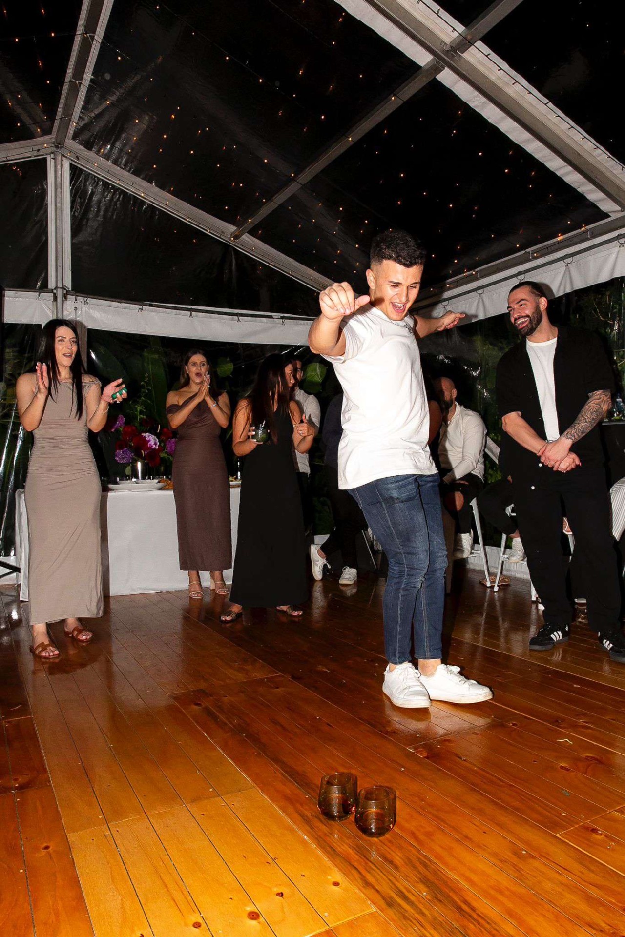 Guest dancing under marquee lights