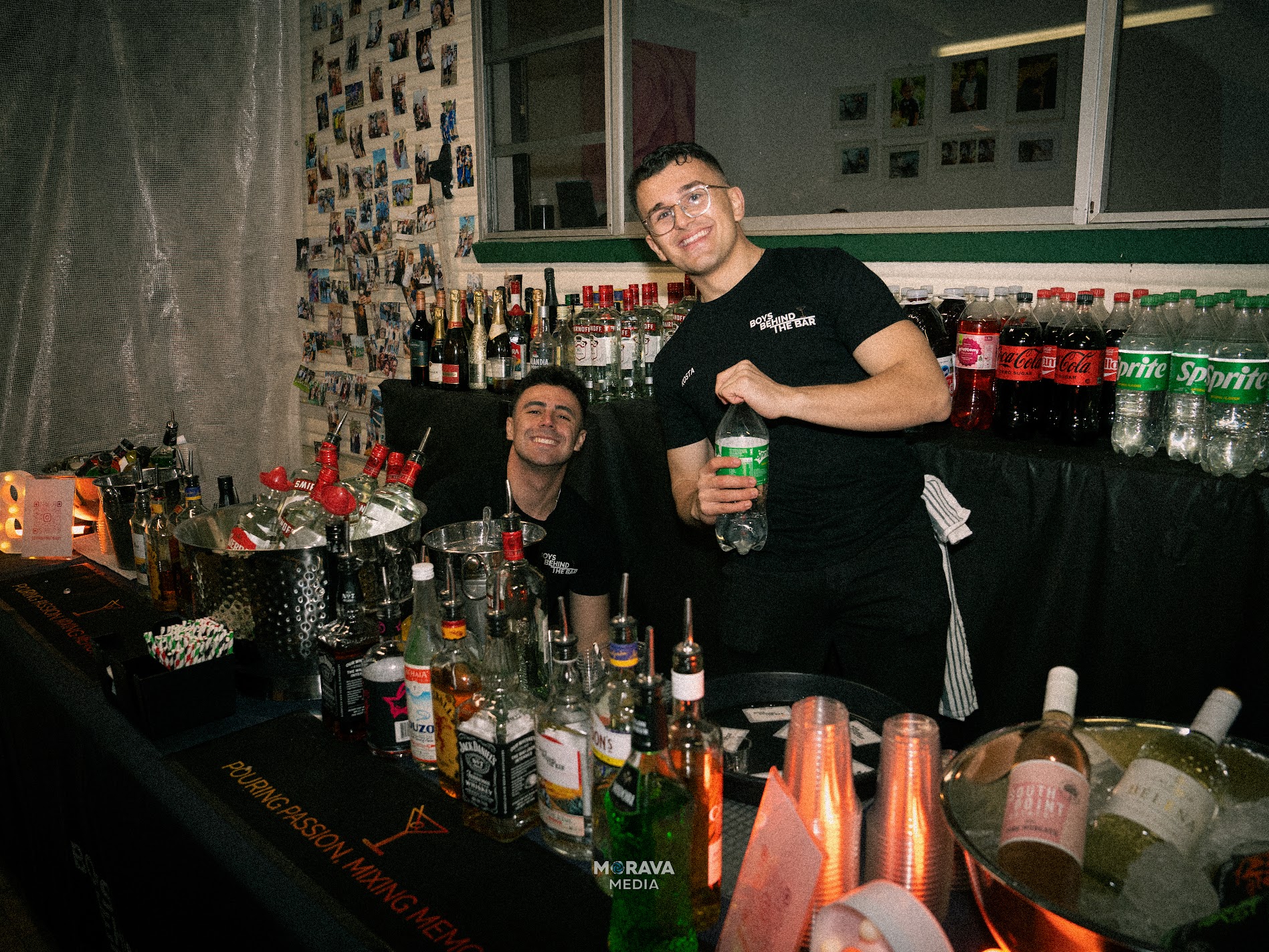 Bartenders behind the bar smiling