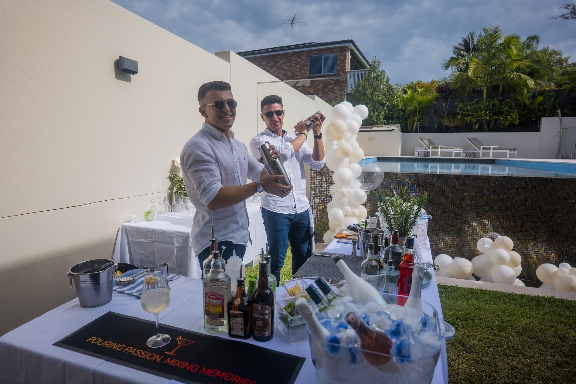 Boys mixing cocktails at poolside setup