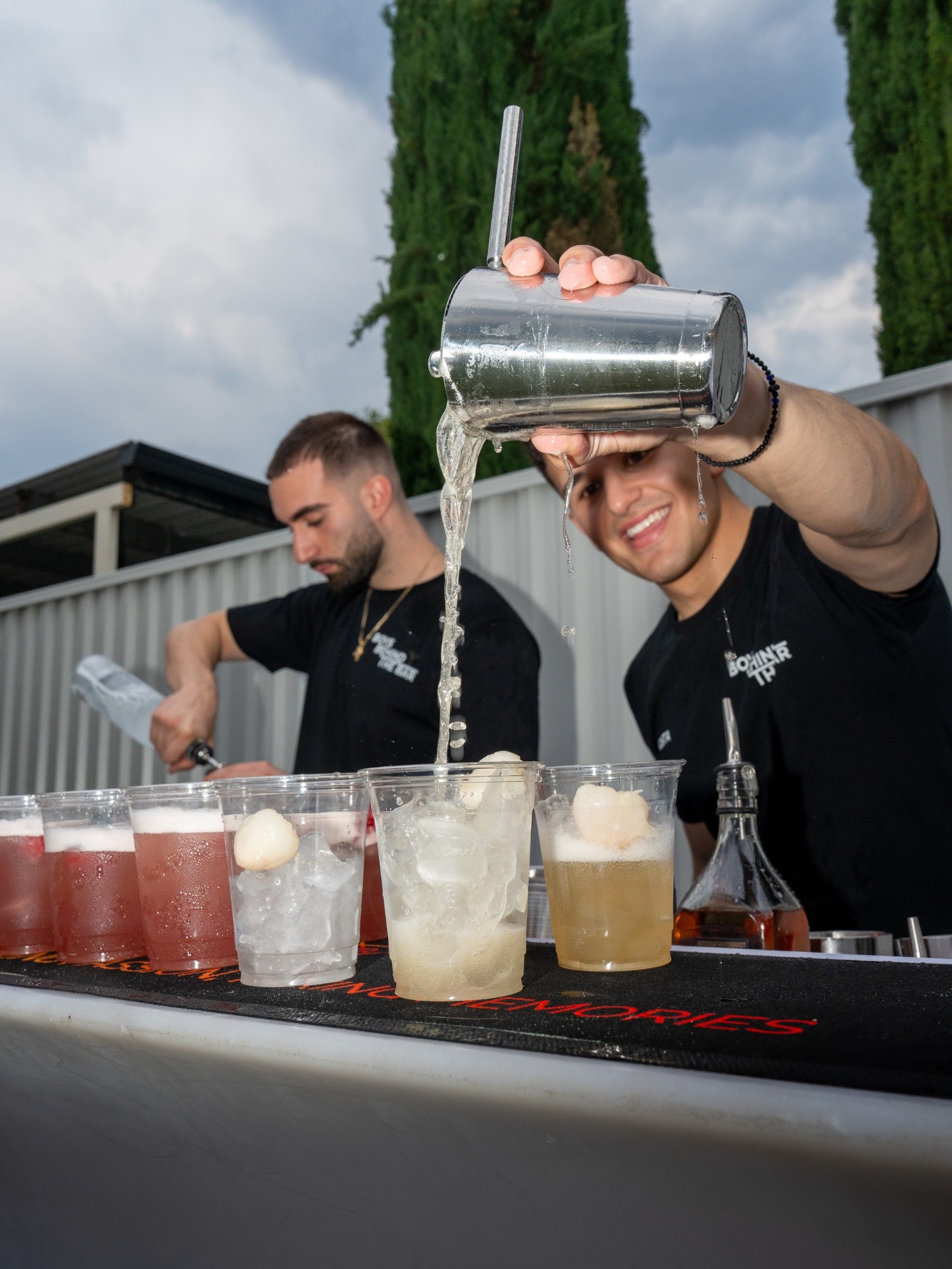 Bartender pouring lychee cocktail
