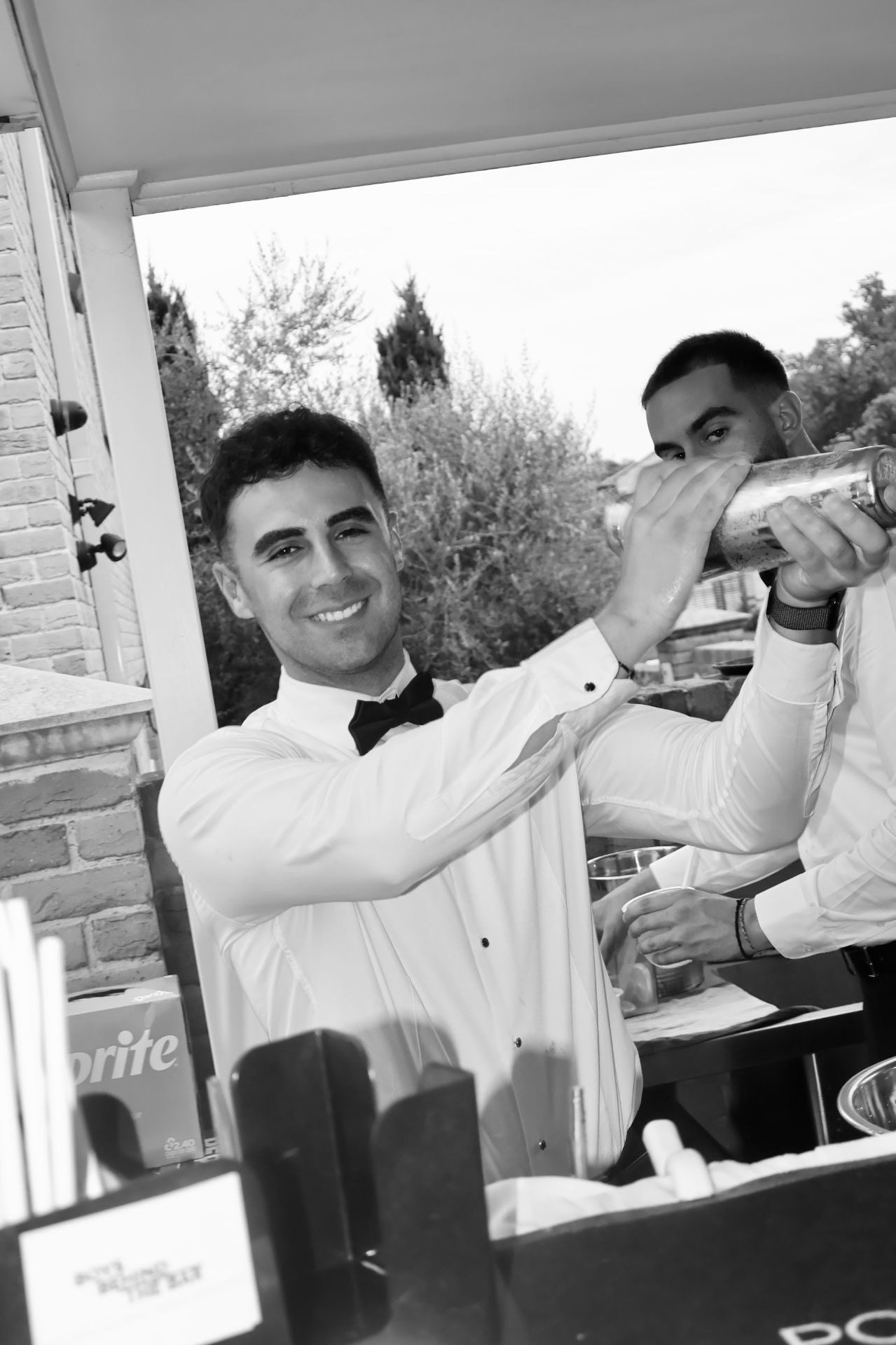 Bartender serving tray of drinks