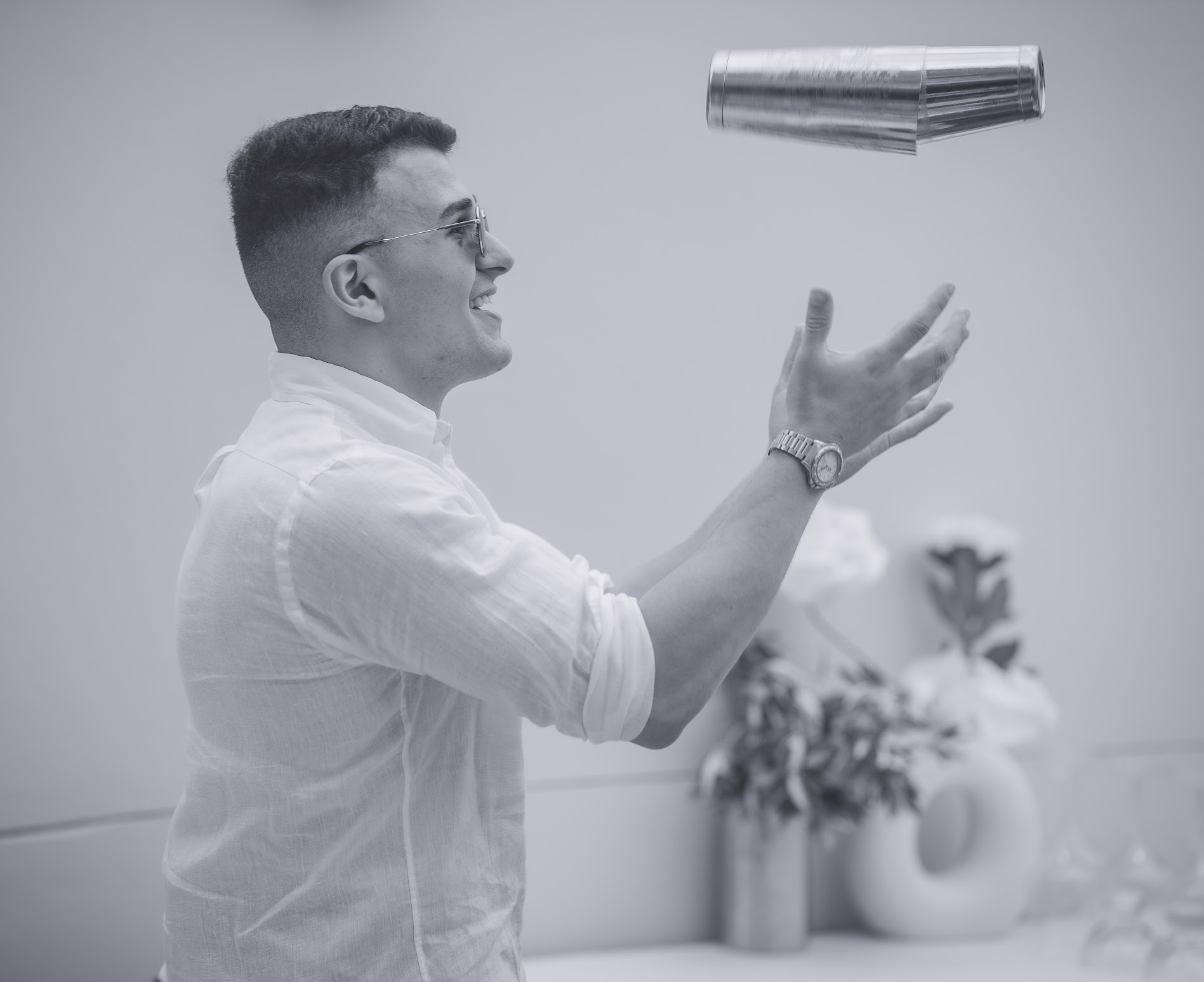 Bartender tossing shaker mid-air